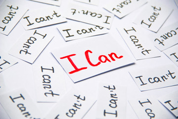 I can. Words of motivation. Concept motivational message of ability and possibility. I can`t and i can are written on peaces of white paper.