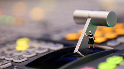 Miniature people : maid cleaning on switcher control of Television Broadcast,color buttons.