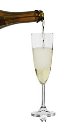 champagne is poured from a bottle into a glass, isolated on a white background