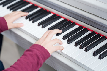 Fototapeta premium Close up of hands of young girl playing piano