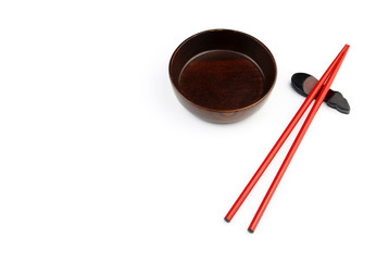 wood Chopsticks and Red bowl for sushi on White background Copy space