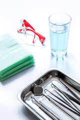 dentists tools in cabinet on white desktop