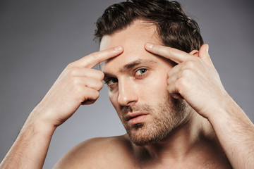 Close up portrait of a young shirtless man