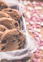Chocolate chip cookies on rustic background with applied retro vintage style filters. Valentine's day concept.