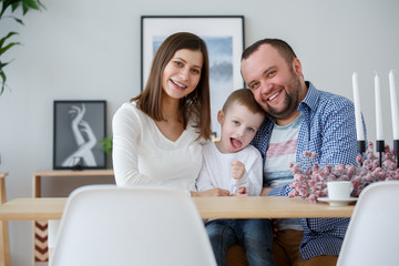 Photo of happy family with son in room