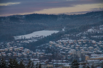 Fototapeta premium The village Tryavna in winter. Sunset