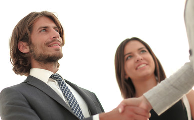 Businesspeople  shaking hands against room with large window loo