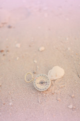 Fototapeta na wymiar pocket compass on sea beach background.