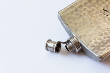 Open vintage metal flask isolated on white, drinking alcoholism addiction concept, copy space, horizontal aspect