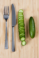 Green cucumbers on chopping board
