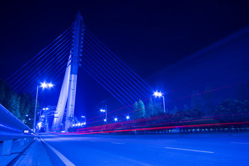 Fototapeta na wymiar lights trails from cars in business center bridge
