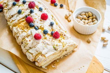 Homemade Meringue Almond Roll with Berries, Pistachios, Cream and Lemon Curd