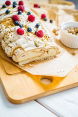 Homemade Meringue Almond Roll with Berries, Pistachios, Cream and Lemon Curd