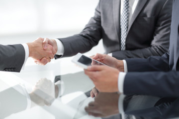 Two confident businessmen shaking hands during a meeting in the
