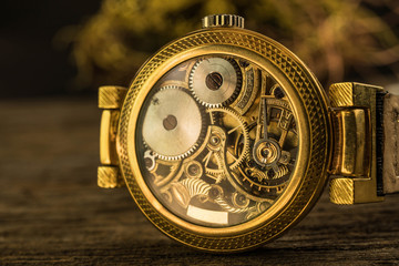 Close up mechanical part of golden vintage watch