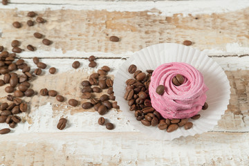 homemade marshmallow cake with currant, mint and Apple addition preparations and coffee beans on a rough wooden surface