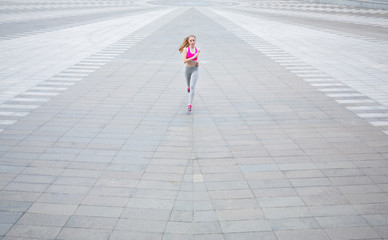 Young woman running in city copy space