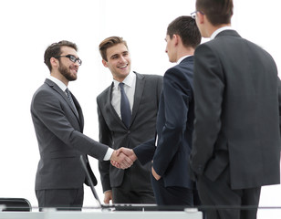 Successful business people shaking hands in an office.