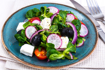 Vegetable salad with black olives and feta