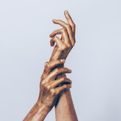 Golden female hands posing