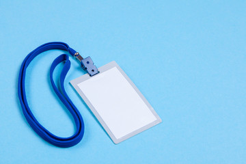 ID card badge with blue ribbon and on a blue background. mock-up. Copy space for text