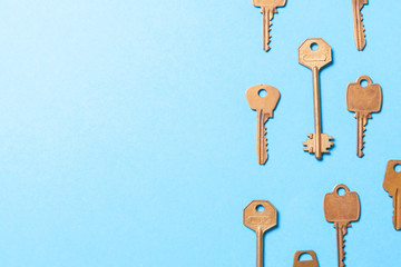 Old gold or copper keys on a blue background. Copy space for text
