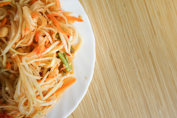 Somtam - Thai famous papaya salad on dish