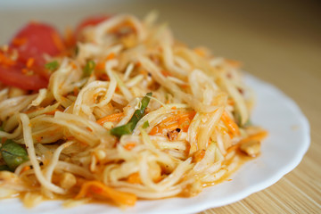 Somtam - Thai famous papaya salad on dish