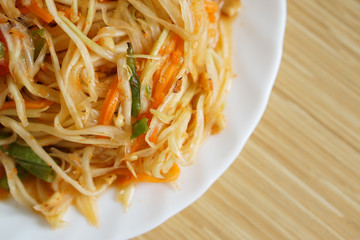 Somtam - Thai famous papaya salad on dish
