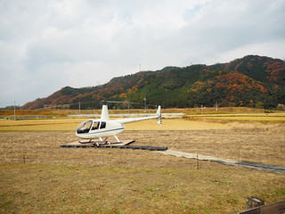 Fototapeta na wymiar Helicopter on autumn field