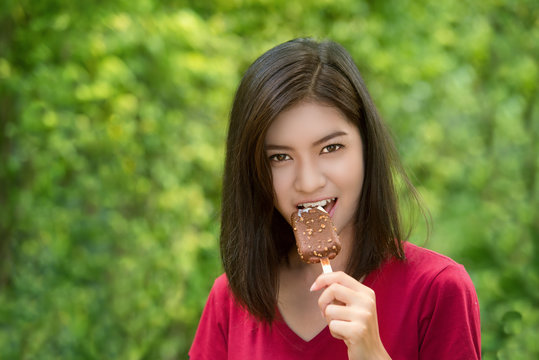 Asian women are eating chocolate ice cream.