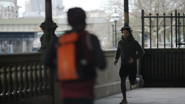Young man jogging in the city, in slow motion