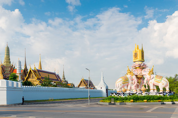 Royal Palace in Bangkok behind a white stone fence, view of the road