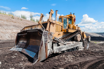 Fototapeta na wymiar Mining Equipment or Mining Machinery, Bulldozer, wheel loader, shovels, loading of coal, ore on the dump truck from open-pit or open-cast mine as the Coal Production.