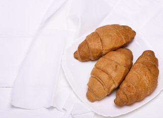 three freshly baked croissants