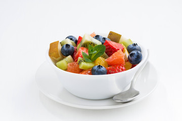 Delicious fruit salad on white table