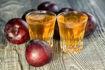 Plum brandy or slivovitz with fresh and tasty plum