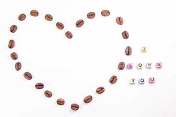 Heart of coffee beans on a white background with a signature I love you and a place for the inscription