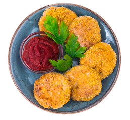 Fish cutlets on blue plate