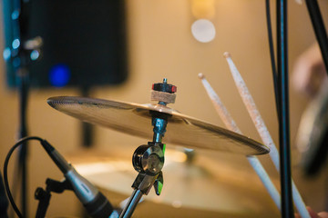 Drum Set with plates and sticks during the concert