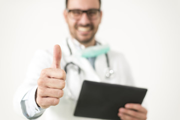 Doctor with digital tablet and thumb up