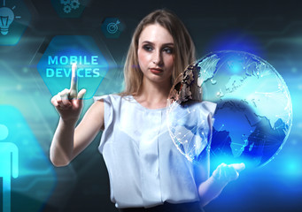 The concept of business, technology, the Internet and the network. A young entrepreneur working on a virtual screen of the future and sees the inscription: Mobile devices