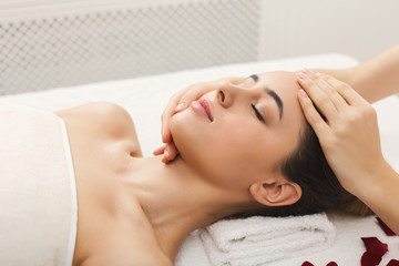 Fototapeta na wymiar Woman getting professional facial massage at beauty salon