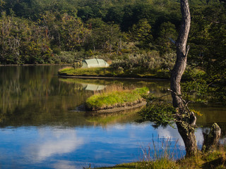 Green camping tent near a lake in Patagonia. Tierra del fuego National Park, Ushuaia