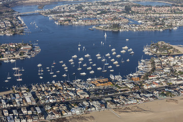 Aerial view of Balboa Bay boats and homes in scenic Newport Beach California.