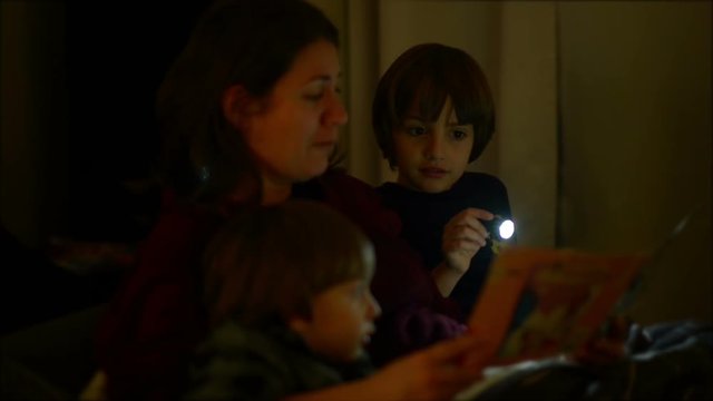Mother reading bedtime stories, to her children