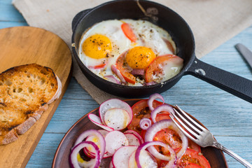 Lunch in a rustic style pub - fried eggs, salad and toasted bread