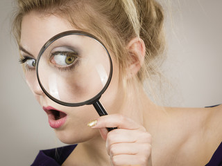 Woman holding magnifying glass investigating