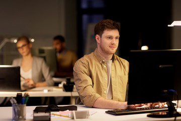 man with computer working late at night office