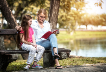 Fototapeta na wymiar Family is reading happily together in the garden.Soft focus concept.
